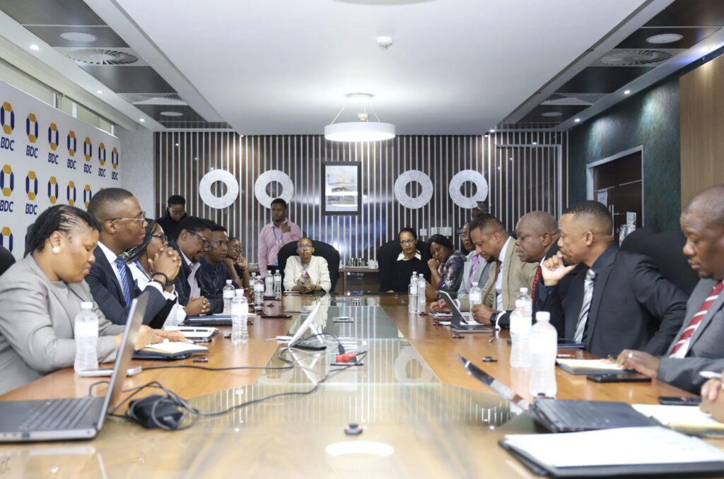 Delegates seated around a boardroom table during a meeting