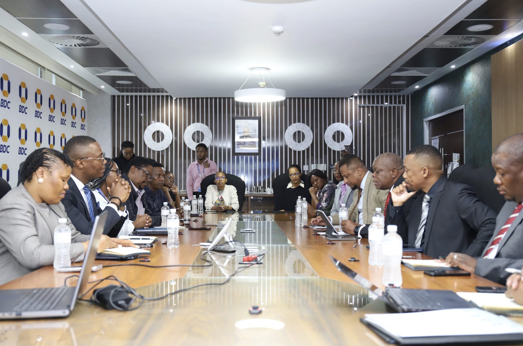 Delegates seated around a boardroom table during a meeting